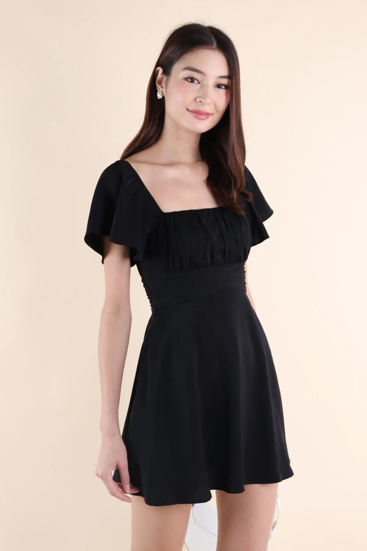 NEVEA RUCHED FLUTTER SLEEVE DRESS IN BLACK