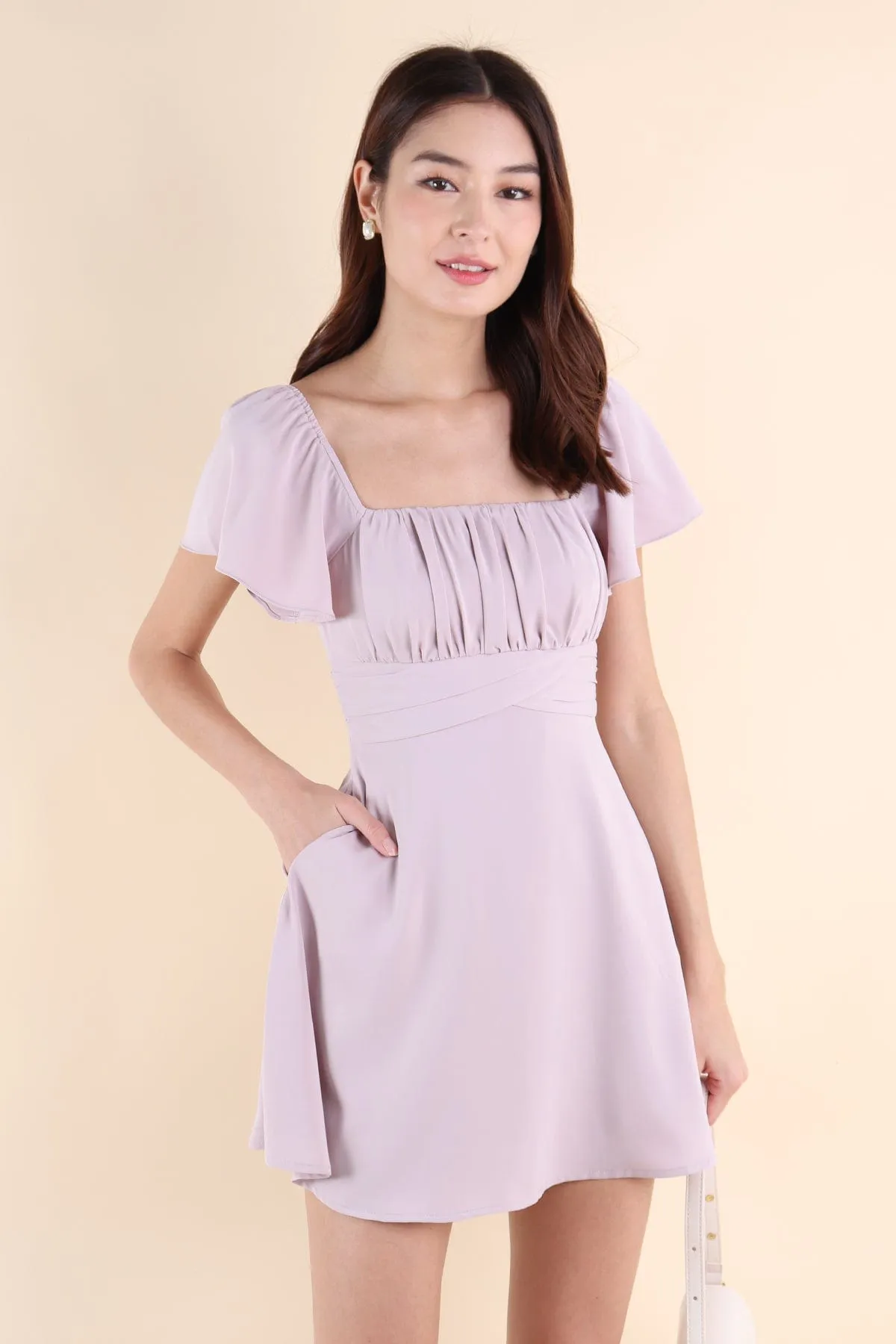 NEVEA RUCHED FLUTTER SLEEVE DRESS IN LILAC PINK