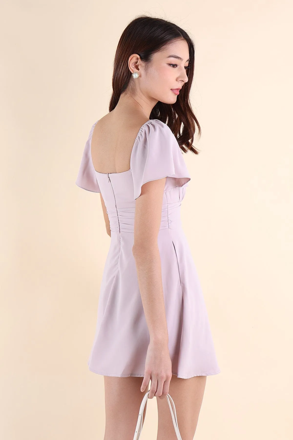 NEVEA RUCHED FLUTTER SLEEVE DRESS IN LILAC PINK