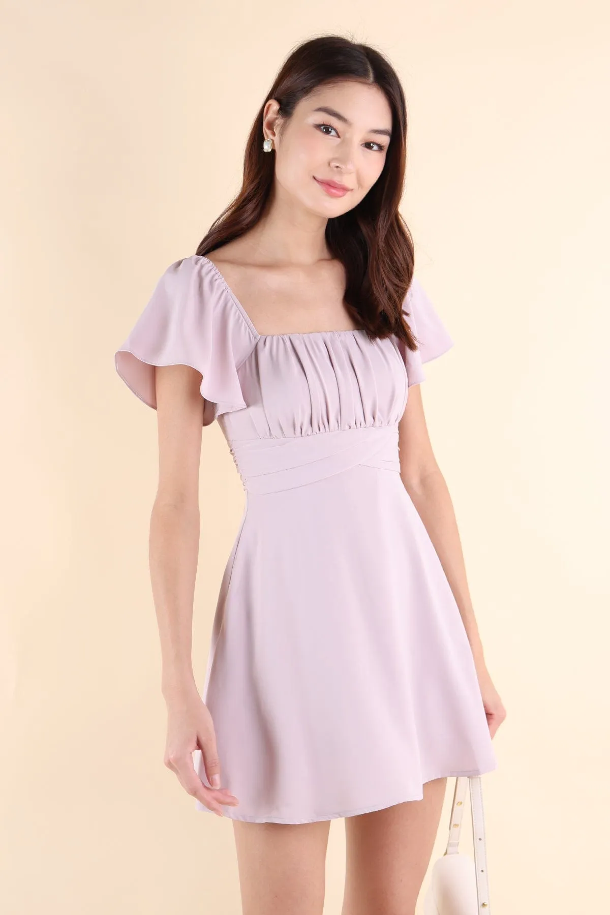 NEVEA RUCHED FLUTTER SLEEVE DRESS IN LILAC PINK